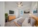 Cozy bedroom featuring wood floors, neutral walls, ceiling fan and natural light at 15062 Sw 63Rd Court Rd, Ocala, FL 34473