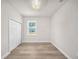 Bright bedroom featuring hardwood floors and a double door closet with natural light from a window at 15062 Sw 63Rd Court Rd, Ocala, FL 34473