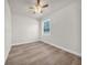 Bright bedroom featuring wood-look floors, a ceiling fan and a window at 15062 Sw 63Rd Court Rd, Ocala, FL 34473