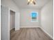 Bedroom featuring wood-look flooring, a window, and a closet at 15062 Sw 63Rd Court Rd, Ocala, FL 34473