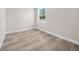 Bright bedroom featuring wood-look flooring and a window providing natural light at 15062 Sw 63Rd Court Rd, Ocala, FL 34473