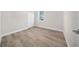 Empty bedroom showcasing bright interiors, a window, and a closet with modern wood-look flooring at 15062 Sw 63Rd Court Rd, Ocala, FL 34473
