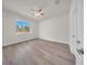 Bedroom features wood-look floors, fan and natural light from the window at 15062 Sw 63Rd Court Rd, Ocala, FL 34473