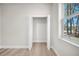Bedroom featuring a walk-in closet with hardwood floors and natural light from a window at 15062 Sw 63Rd Court Rd, Ocala, FL 34473
