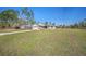 Single-story home with a well-maintained lawn, a paved driveway, and an attached garage at 15062 Sw 63Rd Court Rd, Ocala, FL 34473