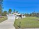 Charming single-story home features a well-manicured lawn and an attached two-car garage at 15062 Sw 63Rd Court Rd, Ocala, FL 34473