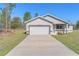 Charming single-Gathering home featuring a long driveway and an attached two-car garage at 15062 Sw 63Rd Court Rd, Ocala, FL 34473
