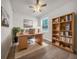 Bright home office featuring a wood desk, bookshelf, and a large window with a view at 15062 Sw 63Rd Court Rd, Ocala, FL 34473