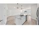 Stylish kitchen island featuring white cabinets, a stainless steel dishwasher, and a double sink at 15062 Sw 63Rd Court Rd, Ocala, FL 34473
