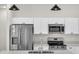Modern kitchen featuring stainless steel appliances, sleek white cabinets, and modern lighting at 15062 Sw 63Rd Court Rd, Ocala, FL 34473