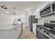 Well-equipped kitchen featuring stainless steel appliances, sleek countertops, and contemporary lighting at 15062 Sw 63Rd Court Rd, Ocala, FL 34473