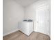 Cozy laundry room features wood-look floors, washer and dryer at 15062 Sw 63Rd Court Rd, Ocala, FL 34473