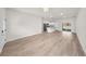 Open-concept living room featuring wood-look floors, modern lighting, and access to a kitchen and outdoor sliding door at 15062 Sw 63Rd Court Rd, Ocala, FL 34473