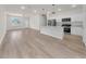 Open-concept floor plan with wood-look floors and modern kitchen at 15062 Sw 63Rd Court Rd, Ocala, FL 34473