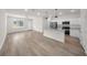 Bright living room with a view of the kitchen featuring stainless steel appliances and island with quartz countertop at 15062 Sw 63Rd Court Rd, Ocala, FL 34473