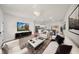 Spacious living room featuring a TV, modern furniture, and decor at 15062 Sw 63Rd Court Rd, Ocala, FL 34473