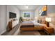 Serene main bedroom with a natural wood bed frame, neutral decor, and ample natural light at 15062 Sw 63Rd Court Rd, Ocala, FL 34473