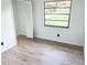 Bright and airy bedroom with hardwood floors, a large window, and a closet at 4814 Lake Shore Dr, St Cloud, FL 34772
