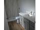 Modern bathroom with gray vanity, white countertop, and walk-in shower at 575 2Nd St, Oviedo, FL 32765