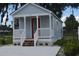 Newly built light gray house with white porch and red front door at 0 2Nd St, Oviedo, FL 32765