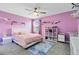 Bedroom with a queen bed, shelves, and a ceiling fan at 2275 Cathedral Rock Dr, Kissimmee, FL 34746