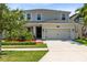 Two-story house with a two-car garage and well-maintained landscaping at 2275 Cathedral Rock Dr, Kissimmee, FL 34746