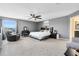 Main bedroom with a king-size bed, armchair, and ceiling fan at 2275 Cathedral Rock Dr, Kissimmee, FL 34746