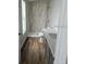 Modern bathroom featuring tile shower, wood flooring, and bright window at 575 2Nd St, Oviedo, FL 32765