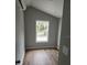 Bedroom with hardwood floors, bright window and modern air conditioning unit at 575 2Nd St, Oviedo, FL 32765