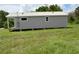 Charming gray cottage featuring a durable metal roof and a cozy, elevated porch entry at 575 2Nd St, Oviedo, FL 32765