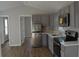 Modern kitchen with stainless steel appliances, gray cabinets, and a spacious layout, ideal for cooking at 575 2Nd St, Oviedo, FL 32765