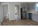 Well-lit kitchen showcasing stainless steel appliances and gray cabinets, adjoining living spaces for seamless living at 575 2Nd St, Oviedo, FL 32765