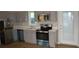 Contemporary kitchen featuring stainless steel appliances and gray cabinets, designed for efficient meal preparation at 575 2Nd St, Oviedo, FL 32765