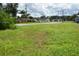 A tranquil view of cottages nestled along a quiet street, surrounded by lush greenery and open space at 575 2Nd St, Oviedo, FL 32765