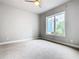 Bright bedroom with carpeted floors and large window at 7770 Sandy Ridge Dr # 18-129, Reunion, FL 34747