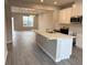 Modern kitchen featuring island, white cabinets, and stainless steel appliances at 9279 Gran Teatro Dr, Winter Garden, FL 34787