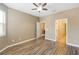 Spacious bedroom with wood-look floors and ceiling fan at 11757 Fitzgerald Butler Rd, Orlando, FL 32836