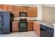 Modern kitchen with wood cabinets and black appliances at 11757 Fitzgerald Butler Rd, Orlando, FL 32836