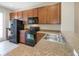 Modern kitchen with wood cabinets, black appliances, and granite counters at 11757 Fitzgerald Butler Rd, Orlando, FL 32836