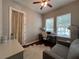 Bright home office features built-in workspace and large window at 1366 Ponce Dr, Celebration, FL 34747