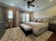 Bright main bedroom with king-size bed, ceiling fan, and hardwood floors at 1366 Ponce Dr, Celebration, FL 34747