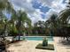 Community pool with lounge chairs and palm trees at 1366 Ponce Dr, Celebration, FL 34747