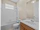 Bright bathroom with white tile, tub-shower combination, and vanity at 143 Brunswick Dr, Davenport, FL 33837