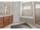 Bright bathroom with a soaking tub, glass-enclosed shower, and stylish tile accents at 143 Brunswick Dr, Davenport, FL 33837