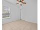 Bright bedroom with a large window, neutral colors, and closet space at 143 Brunswick Dr, Davenport, FL 33837