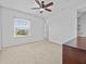 Bedroom showcasing neutral carpet, large window, and a closet, perfect for relaxation at 143 Brunswick Dr, Davenport, FL 33837