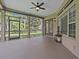 Covered lanai with screened openings, ceiling fan, and view of the backyard at 143 Brunswick Dr, Davenport, FL 33837