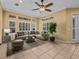 Spacious living room featuring neutral décor, tile floors, and plenty of natural light from large windows at 143 Brunswick Dr, Davenport, FL 33837