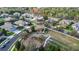 Aerial view of the neighborhood showcases a playground and lush greenery surrounding the residences at 15558 Sandfield Loop, Winter Garden, FL 34787