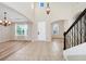 Inviting foyer with high ceilings, tile flooring, wrought iron staircase and natural light at 15558 Sandfield Loop, Winter Garden, FL 34787